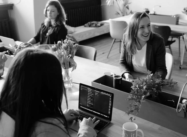 three women having a meeting